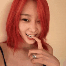 a woman with red hair has a ring on her finger that says ' i love you '