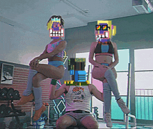 a man in a tank top with a tiger on it sits in a gym with two women