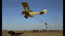 a man is being pulled by a yellow plane that says the great wall of china on the side