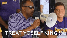 a man is holding a megaphone in front of a group of people and says `` treat yoself king '' .