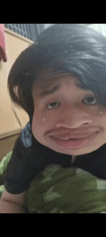 a close up of a person making a funny face with piercings on their face