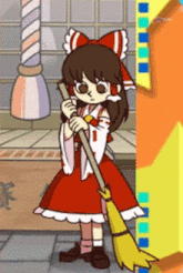 a girl in a red dress is holding a yellow broom