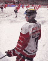 a hockey player in a red and white jersey with the number 7 on it