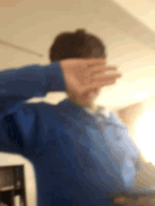a blurry picture of a person covering their ears