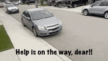 a car is driving down the street with the words help is on the way dear