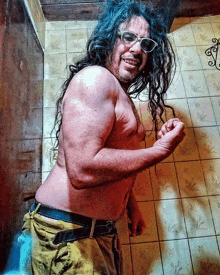 a shirtless man with long hair is wearing sunglasses and a belt