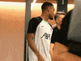 a man wearing a white shirt that says axa on it