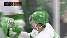 hockey player wearing a green helmet that says ortho