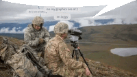 a couple of soldiers are sitting on top of a hill looking through binoculars .