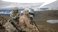 a couple of soldiers are sitting on top of a hill looking through binoculars .