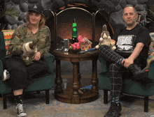 a man and a woman are sitting in chairs with stuffed animals on a table