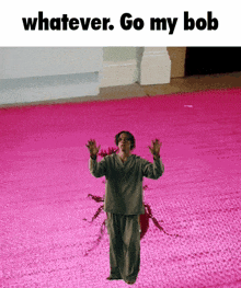 a man standing on a pink carpet with the words " whatever go my bob " below him