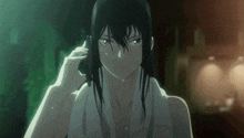 a woman with a towel around her neck looks at the camera