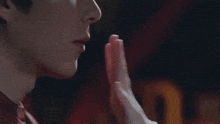 a man with a ring on his finger is touching another man 's face .