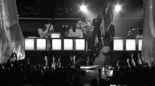 a black and white photo of a group of people on stage