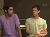 two men are sitting next to each other in front of a cartoon channel logo
