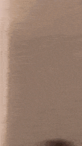 a blurred image of a corner of a room with a white wall