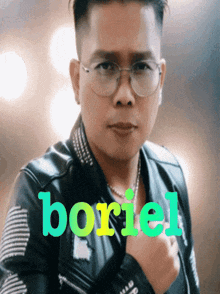 a man wearing glasses and a leather jacket with the word boriel written in green