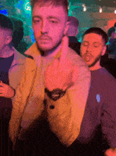 a man giving the middle finger in a crowded room