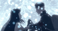 a man and a woman hold hands in the snow