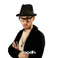 a man wearing a hat and glasses has the word mcdh on the bottom right