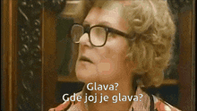 a woman wearing glasses and a plaid shirt says glava