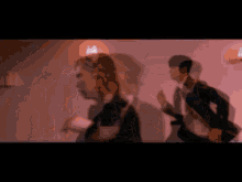a man in a suit and tie is running in a hallway