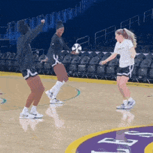 a group of women are playing basketball on a court that says ucsd on it