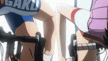 a person wearing a shirt that says " gaku " is riding a bike