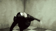 a man in a suit is doing a handstand