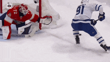 a hockey player with the number 91 on his jersey is skating on the ice