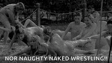 a group of young girls are playing in the mud naked wrestling .