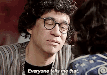 a man wearing glasses and a wig is talking to a woman .