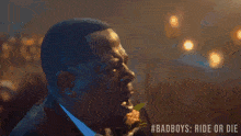 a man in a tuxedo is dancing in front of a crowd with the hashtag badboys ride or die