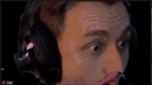 a man wearing headphones looks surprised in a blurry photo
