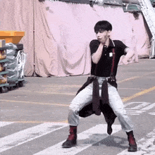 a man in a black shirt with the letter n on it is dancing