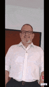 a man with a beard and glasses is wearing a white shirt and a tie with the letter r on it .