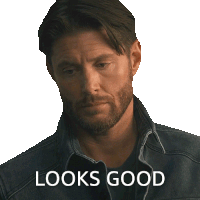 a man with a beard wearing a denim jacket with the words looks good written below him