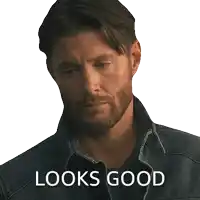 a man with a beard wearing a denim jacket with the words looks good written below him