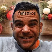 a man with the word fanatikos on his forehead is smiling