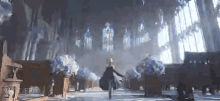 a woman is walking through a church with stained glass windows and flowers .