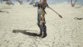 a man with a tattoo on his arm is standing in the desert holding a sword