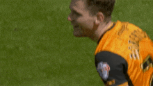 two soccer players hugging each other on the field .