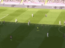 a soccer game is being played on a field with a few players wearing jerseys that say fc barcelona