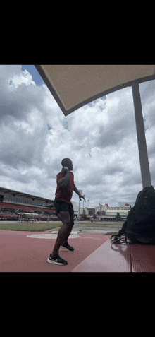 a man in a red shirt jumps in the air