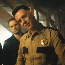 a man in a sheriff 's uniform has a badge on his chest that says usd