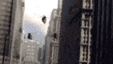 a group of helicopters are flying over a city with buildings in the background .