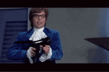 a man in a blue suit is holding a gun with the word go above him