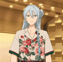 a man with long white hair and a floral shirt