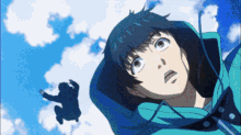 a man in a blue jacket looks up at the sky